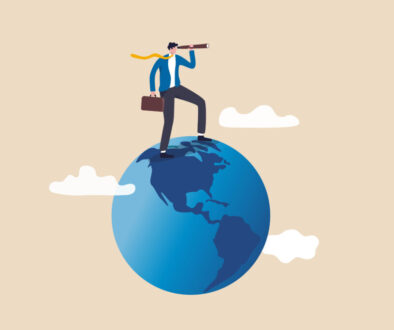 Globalization, global business vision, world economics or business opportunity concept, smart businessman standing on globe, planet earth using telescope to see vision or future opportunity.